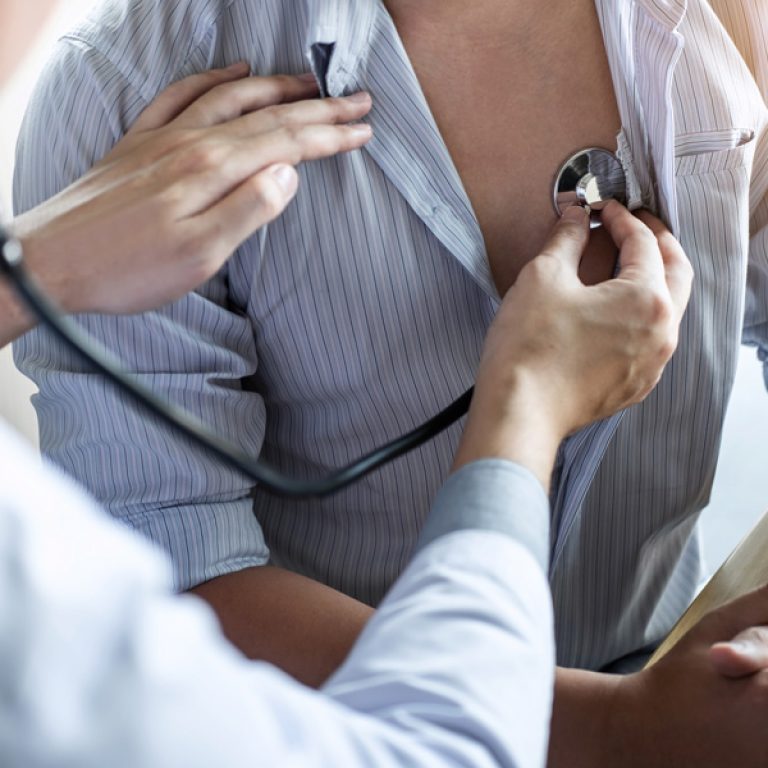 Doctor using a stethoscope to listen to a man's chest during a Cardiovascular Health checkup, offering services like low testosterone treatment, weight management, preventative care, chronic condition management, concierge healthcare, and facial and body scans at Men's Only Medical in West Palm Beach and Palm Beach.